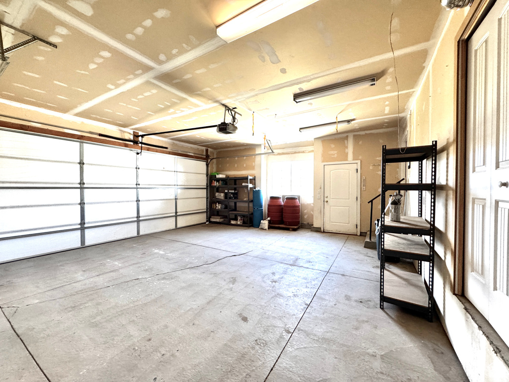 Garage featuring a garage door opener