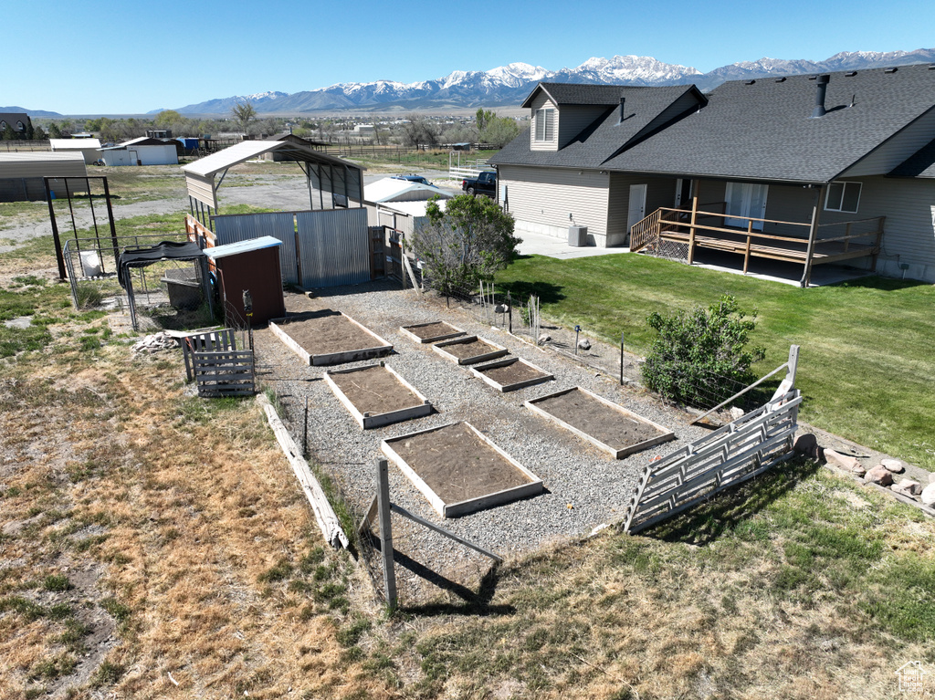 View of yard with a mountain view and a vegetable garden