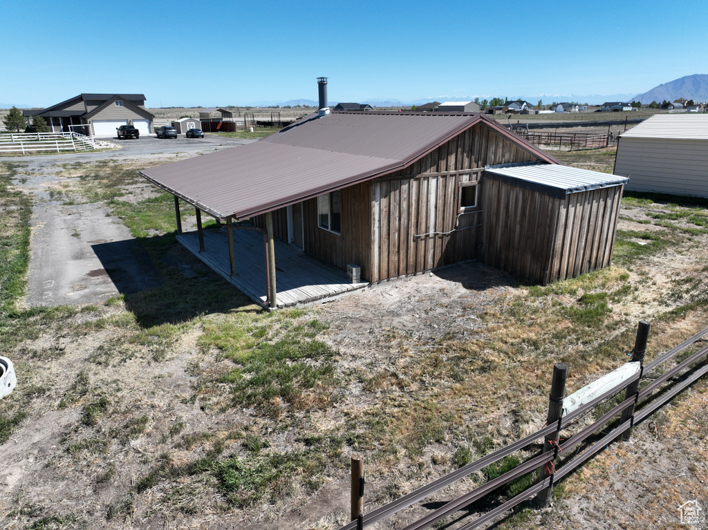 Exterior space featuring fence and metal roof