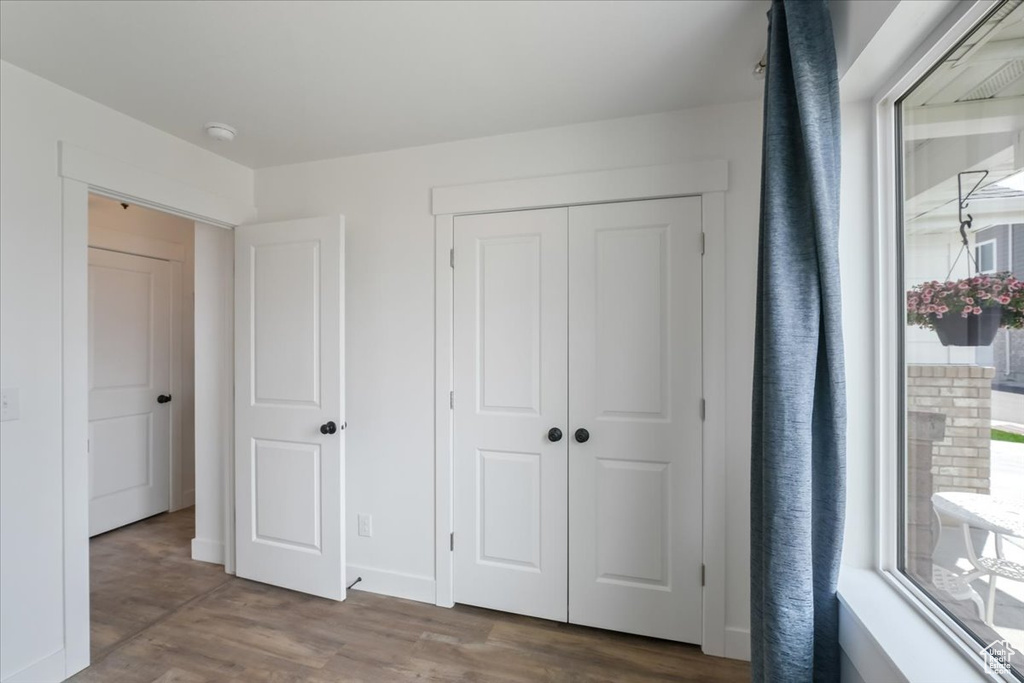 Unfurnished bedroom featuring wood finished floors and a closet
