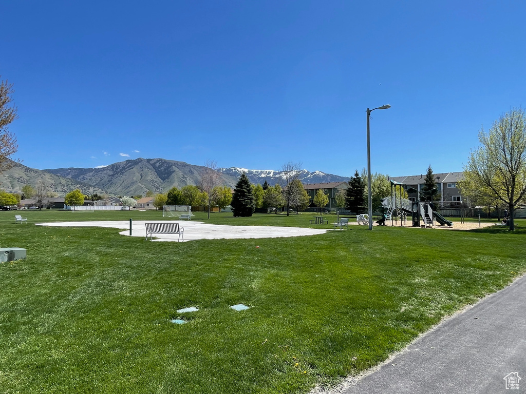 View of home\\\'s community with a yard, a mountain view, and playground community