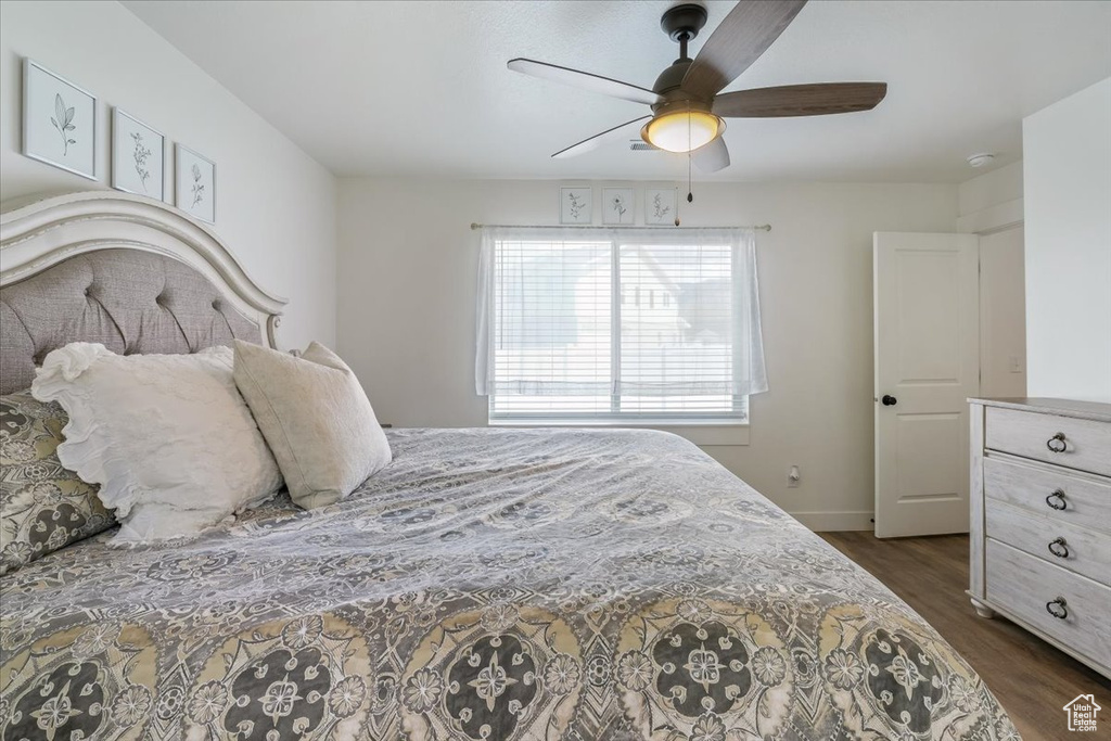Bedroom with baseboards, a ceiling fan, and dark wood finished floors
