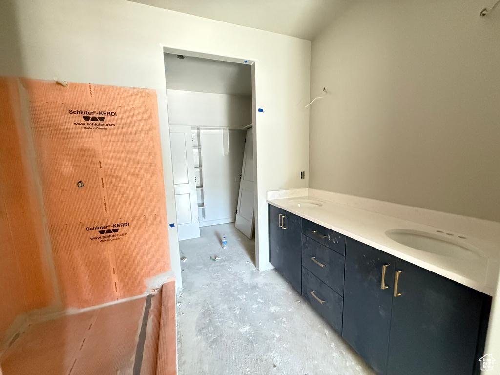 Bathroom featuring double vanity and a sink