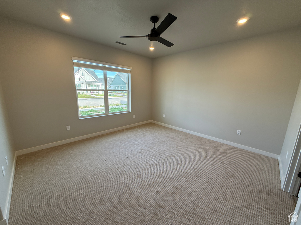 Spare room featuring a ceiling fan, carpet flooring, recessed lighting, and baseboards