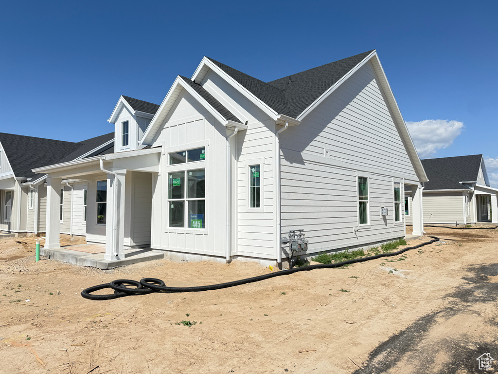 View of side of home featuring a porch and board and batten siding