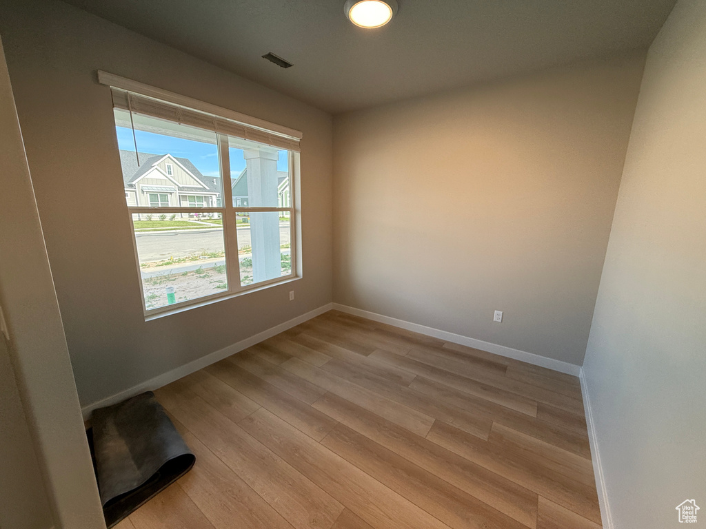 Spare room with light wood-style floors and baseboards