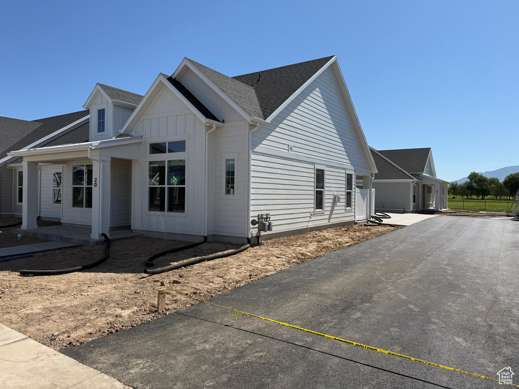 View of side of property featuring board and batten siding and driveway