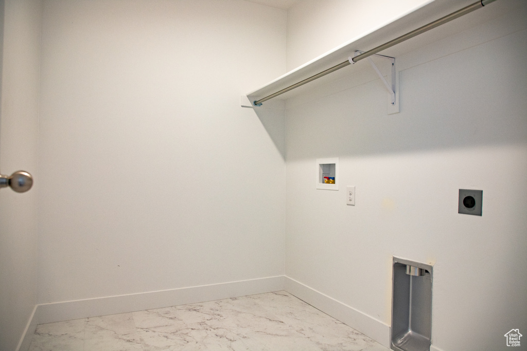 Laundry room with washer hookup, light marble finish floors, and electric dryer hookup