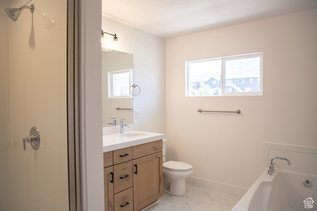 Bathroom featuring marble look tile flooring, a bath, vanity, and a shower