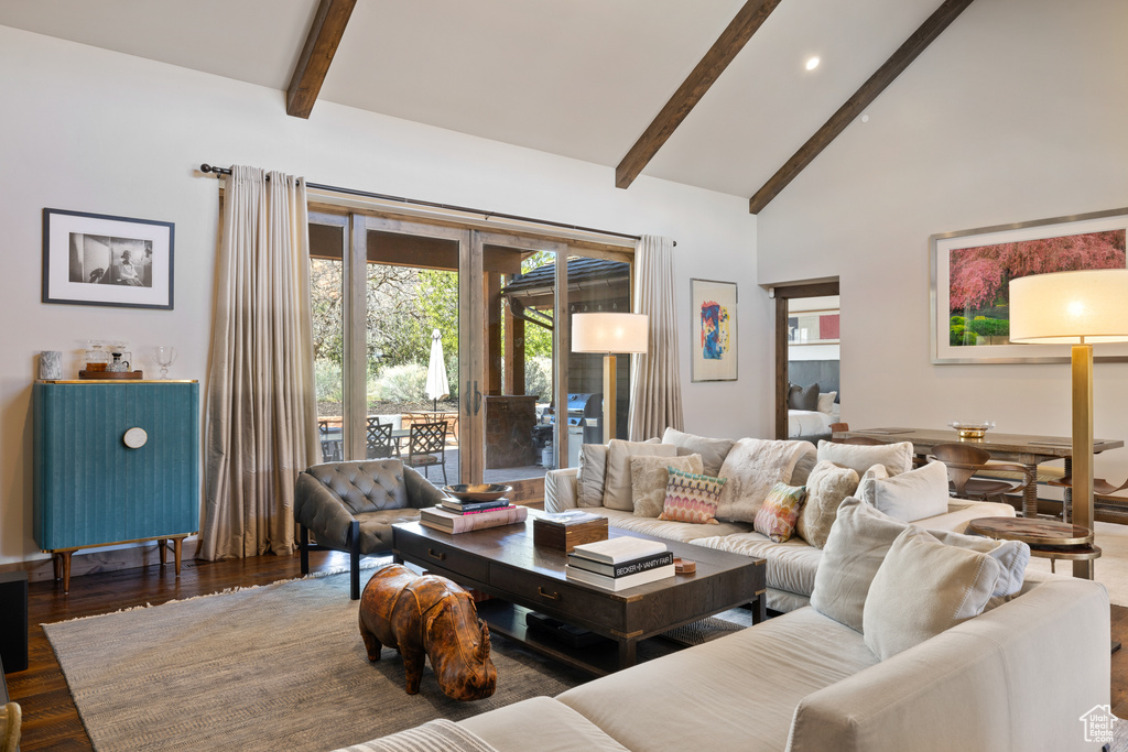 Living room with recessed lighting, beamed ceiling, wood finished floors, and high vaulted ceiling