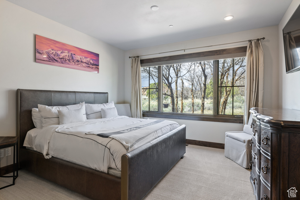 Bedroom featuring baseboards, recessed lighting, and light colored carpet