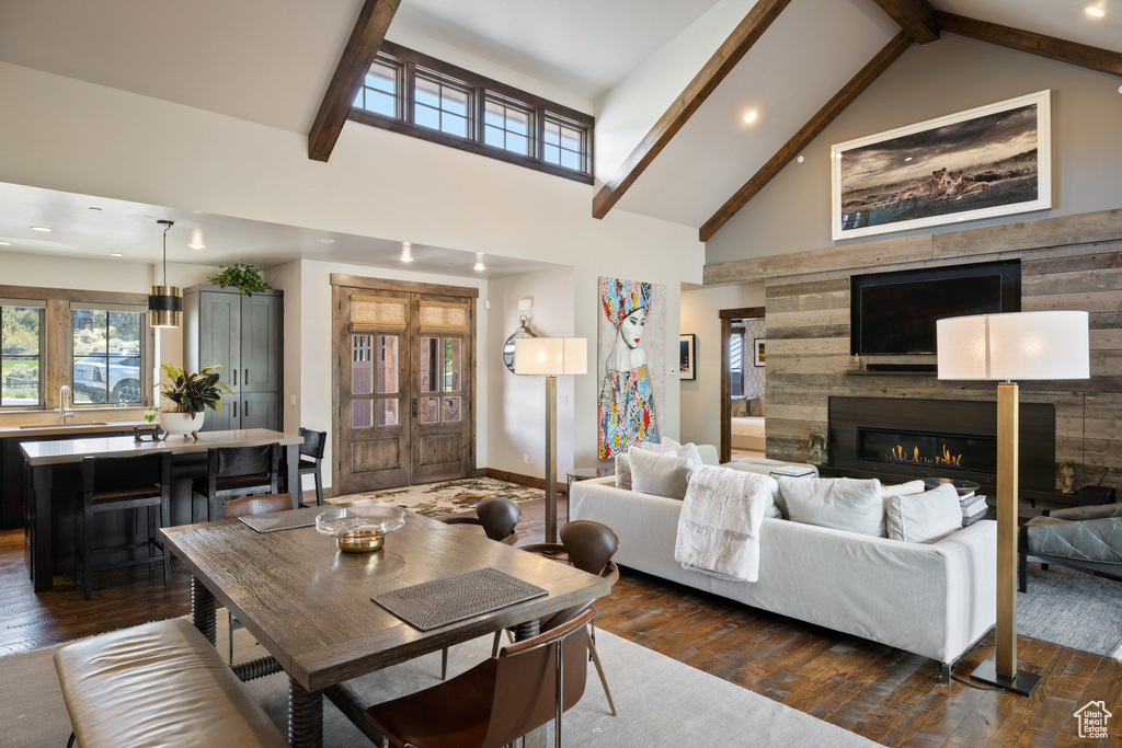 Living area featuring recessed lighting, beamed ceiling, and dark wood-style floors