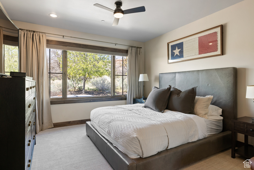 Bedroom with recessed lighting, baseboards, light colored carpet, and a ceiling fan