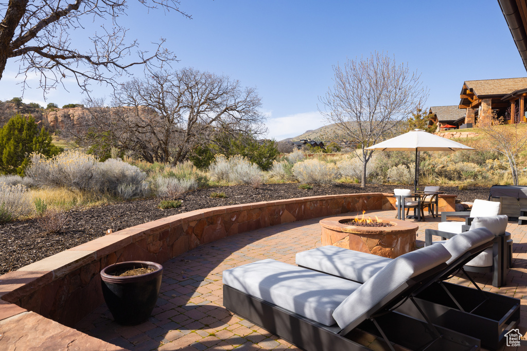 View of patio / terrace featuring a fire pit and a mountain view