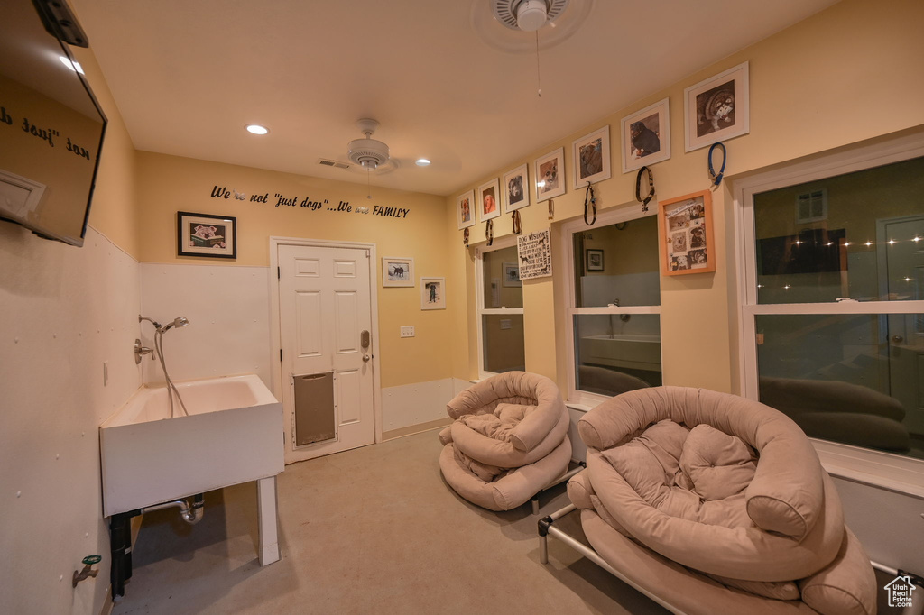 Sitting room featuring recessed lighting, ceiling fan, and carpet