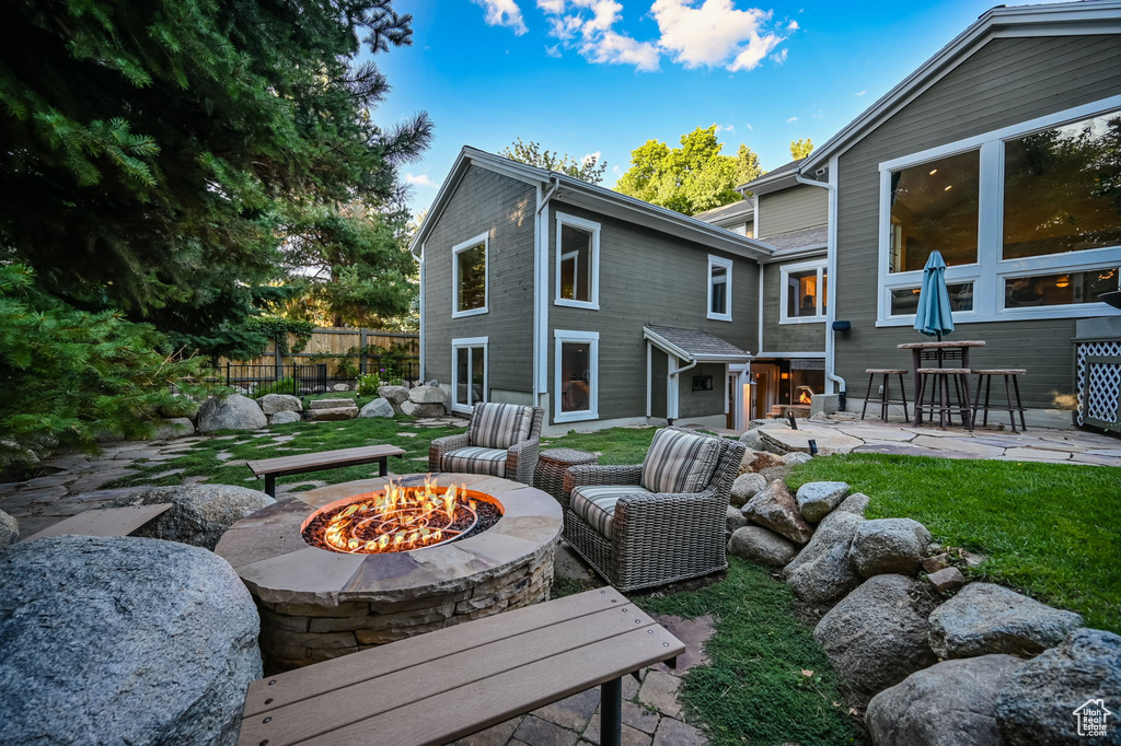 View of patio featuring fence and an outdoor fire pit