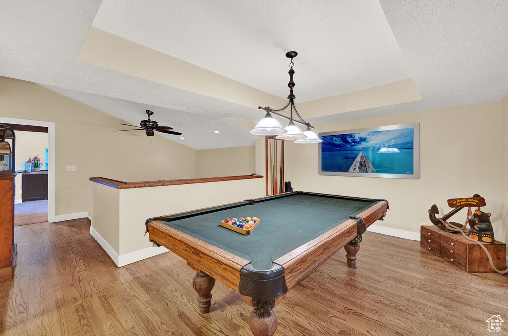 Game room featuring baseboards, a raised ceiling, wood finished floors, and pool table
