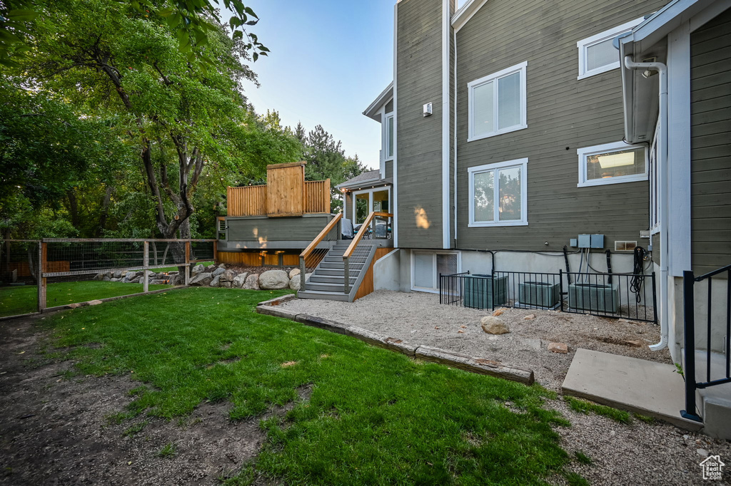 View of yard with a fenced backyard and stairway