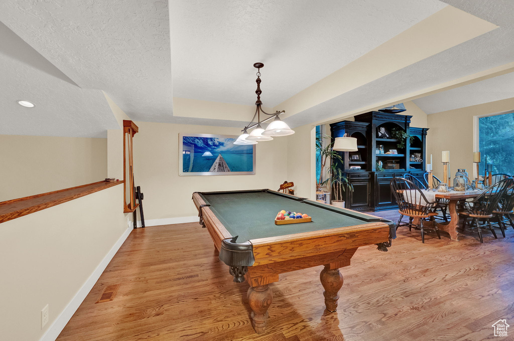 Rec room featuring baseboards, a textured ceiling, wood finished floors, and pool table