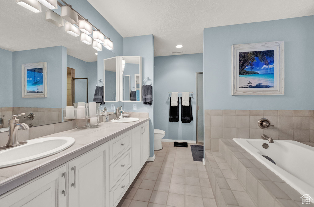 Full bathroom with tile patterned flooring, a sink, a bath, and a shower stall