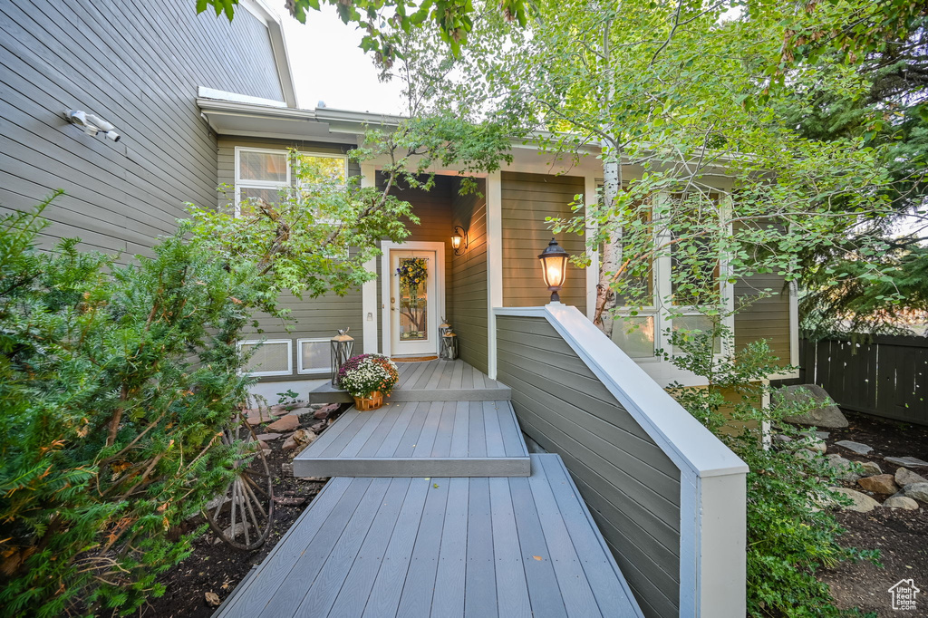 Wooden terrace featuring fence