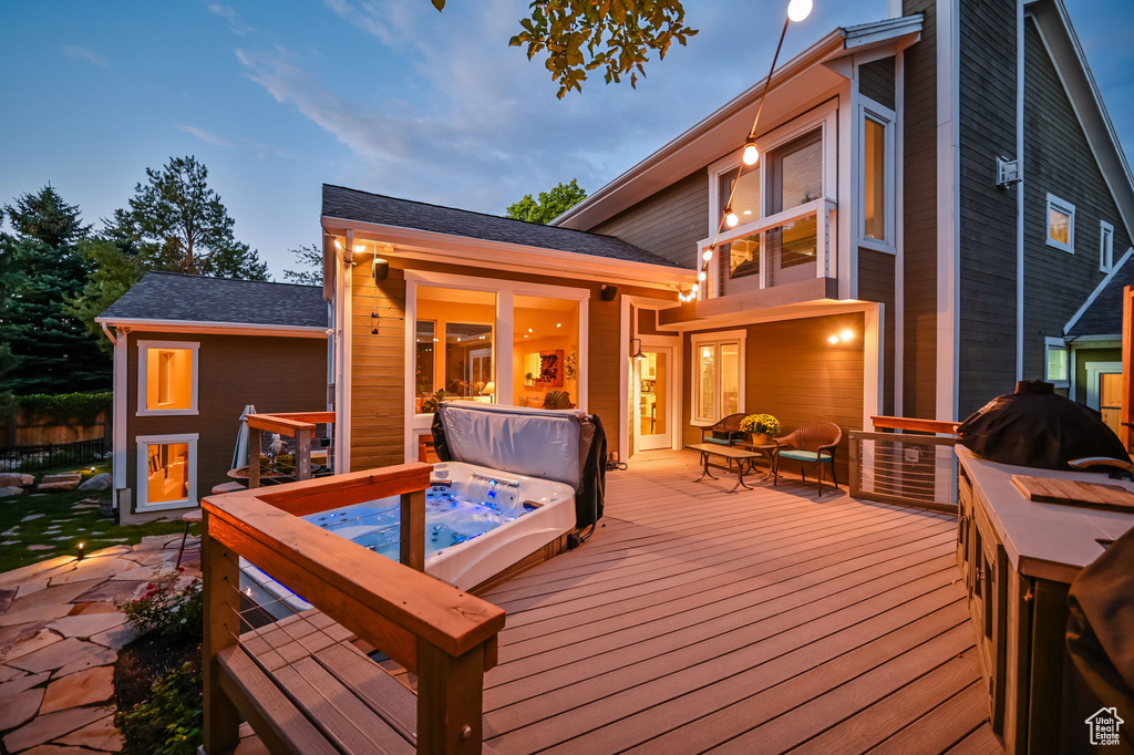 Wooden terrace with a covered hot tub