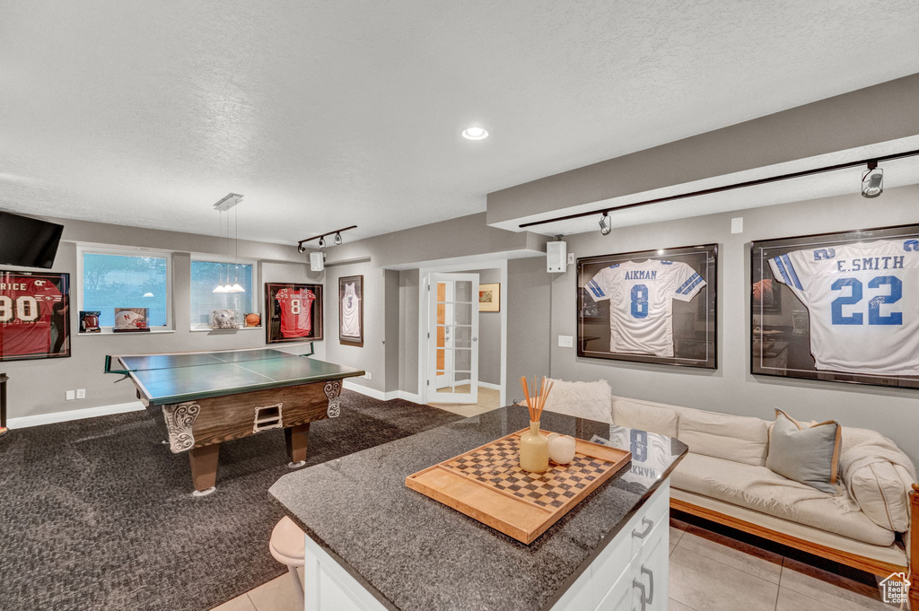 Recreation room featuring baseboards, recessed lighting, a textured ceiling, and track lighting