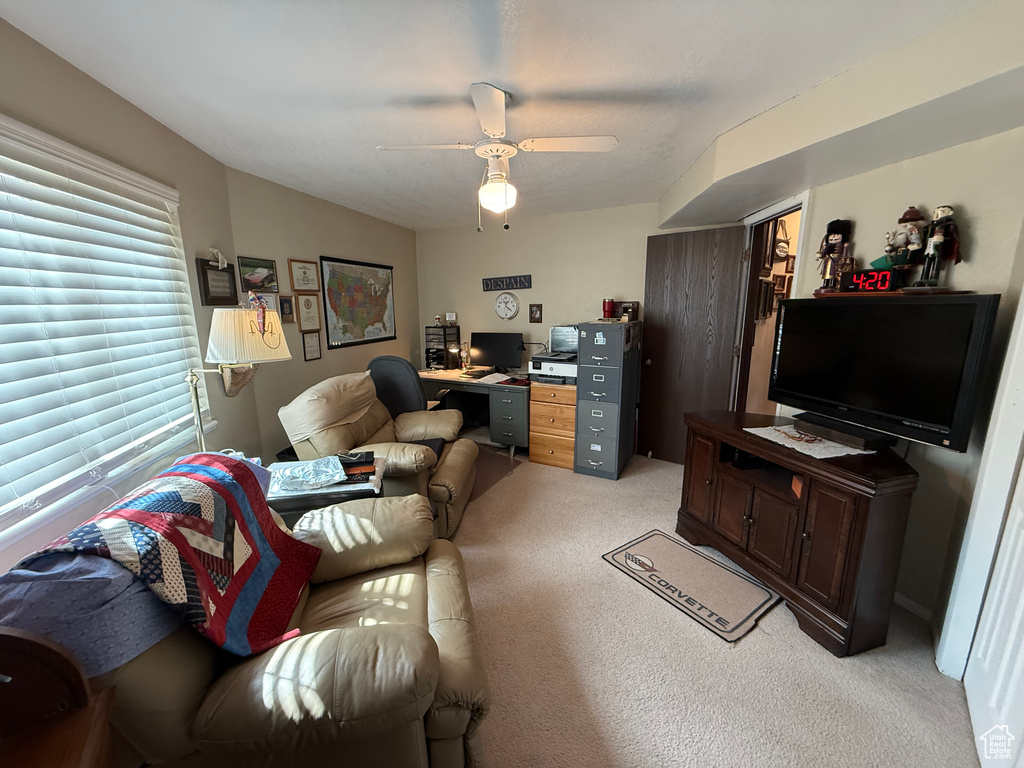 Living room featuring light colored carpet and ceiling fan