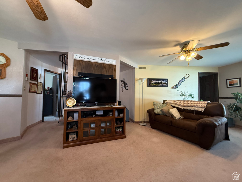 Living area featuring baseboards, ceiling fan, light carpet, and visible vents