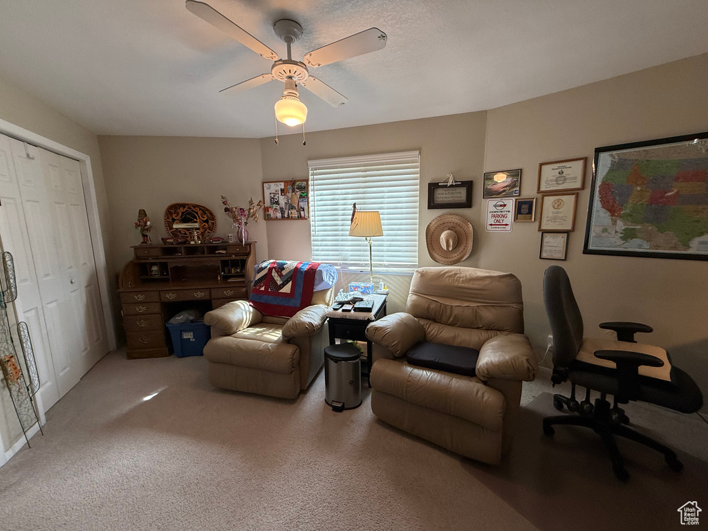Living room with carpet floors and ceiling fan