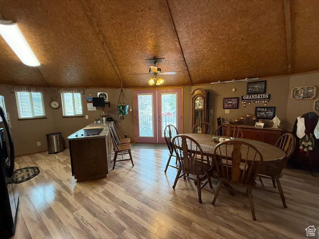 Dining room featuring a wealth of natural light, french doors, and light wood-style flooring