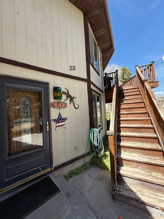 Property entrance featuring a wooden deck