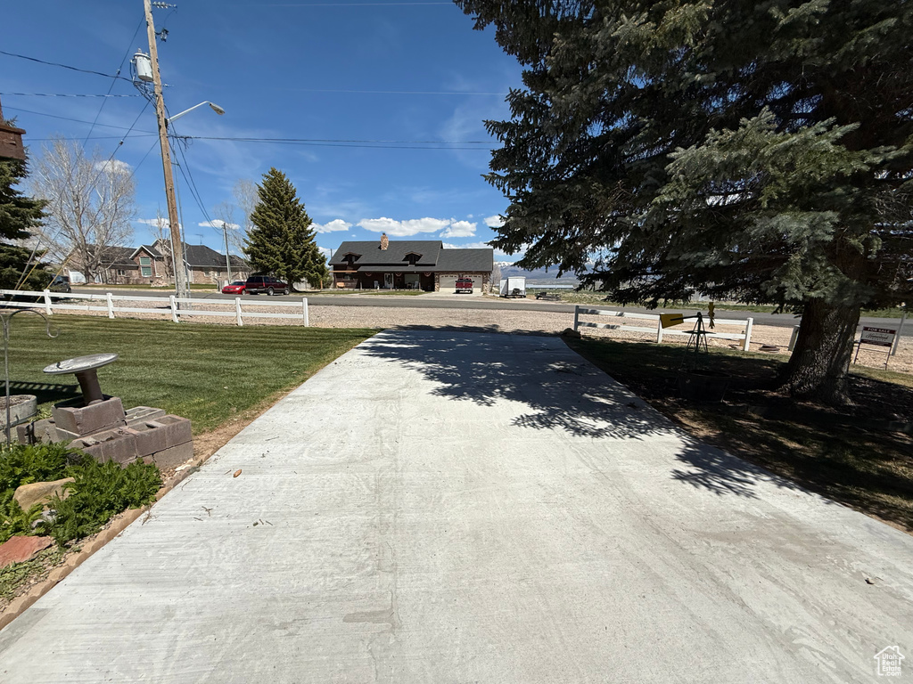 View of street with street lights and concrete driveway
