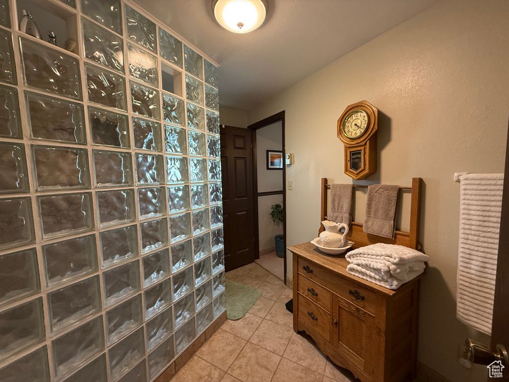 Bathroom with a walk in shower and tile patterned flooring