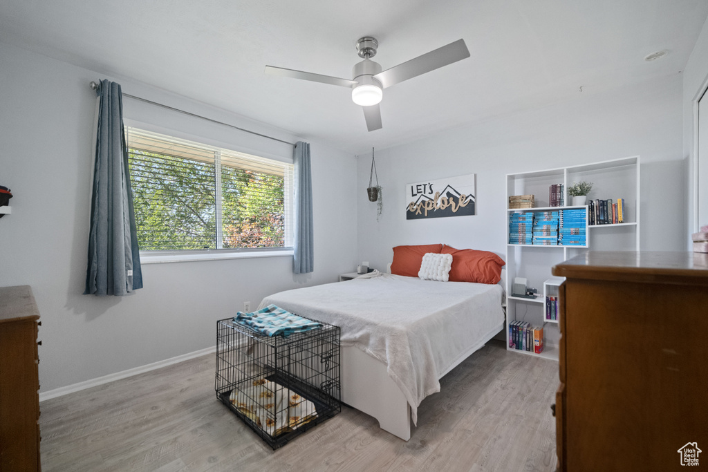 Bedroom with baseboards, ceiling fan, and wood finished floors