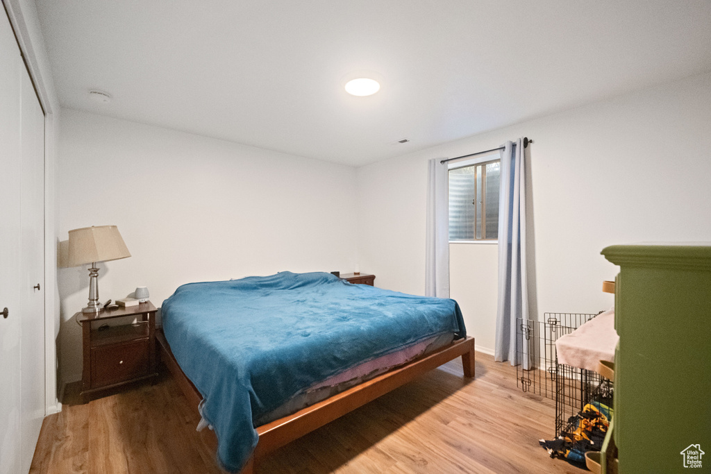Bedroom with baseboards and wood finished floors