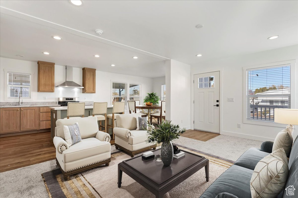 Living area featuring light wood-style floors, baseboards, and recessed lighting