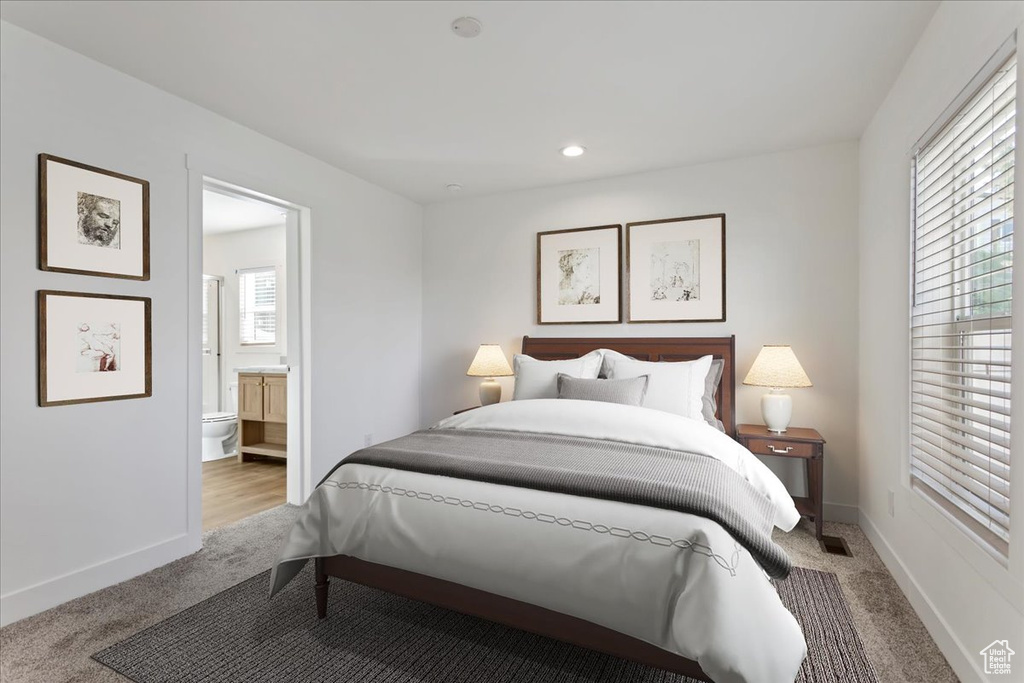 Bedroom featuring carpet flooring, recessed lighting, baseboards, and ensuite bath