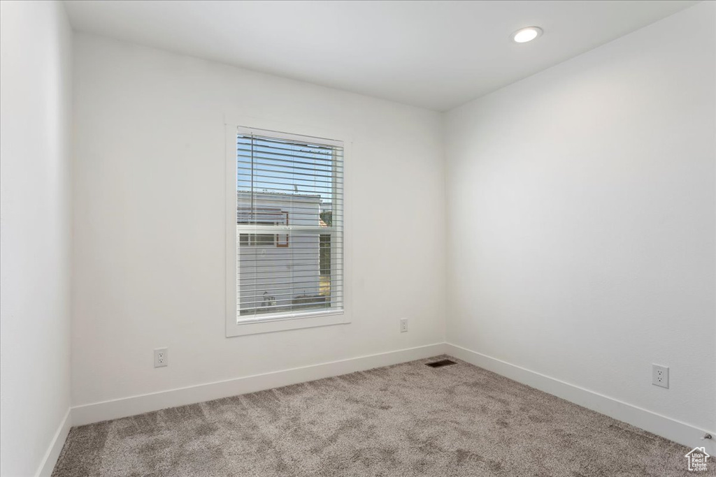 Unfurnished room with carpet floors, recessed lighting, baseboards, and visible vents