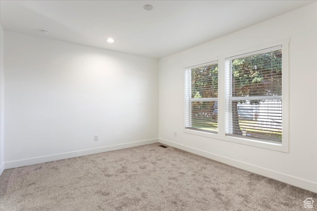 Unfurnished room with carpet flooring, recessed lighting, baseboards, and visible vents