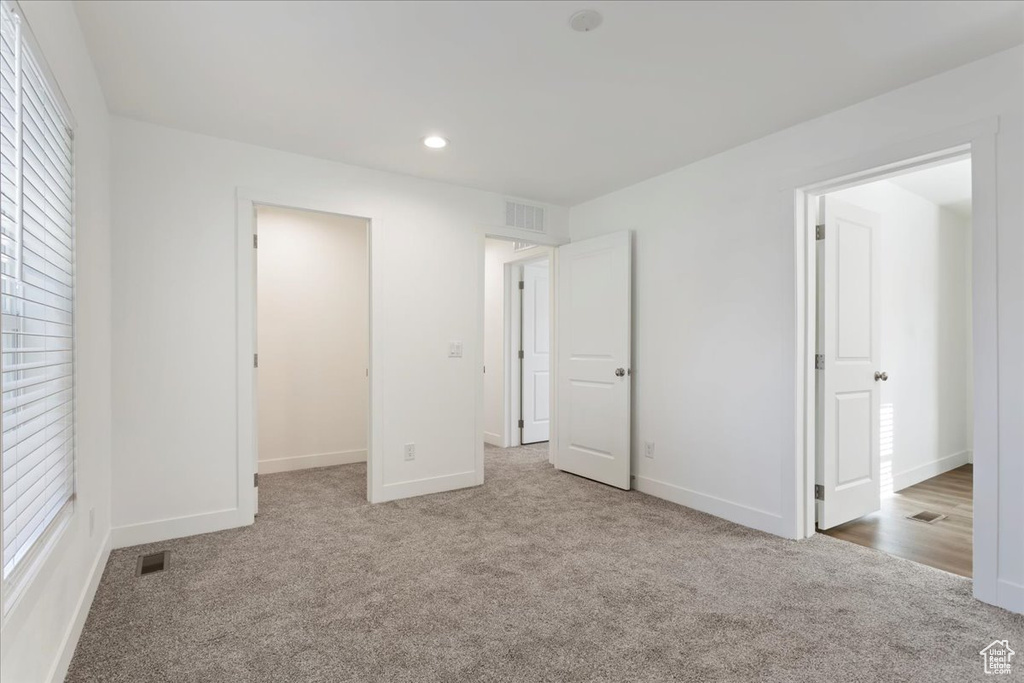 Unfurnished bedroom featuring visible vents, recessed lighting, carpet, and baseboards