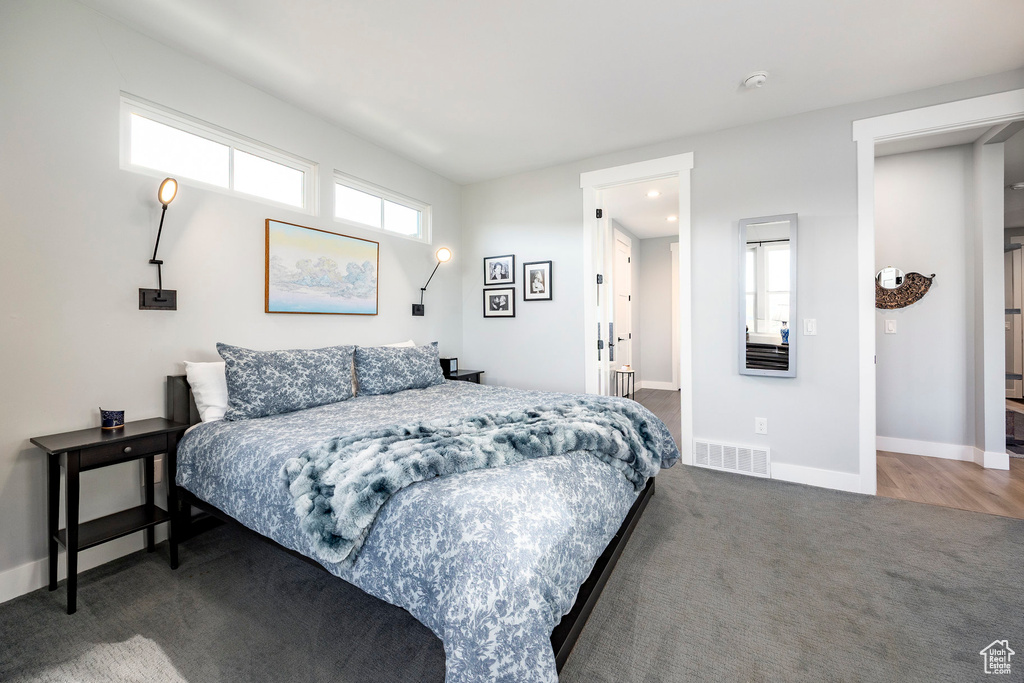Bedroom featuring carpet floors and baseboards