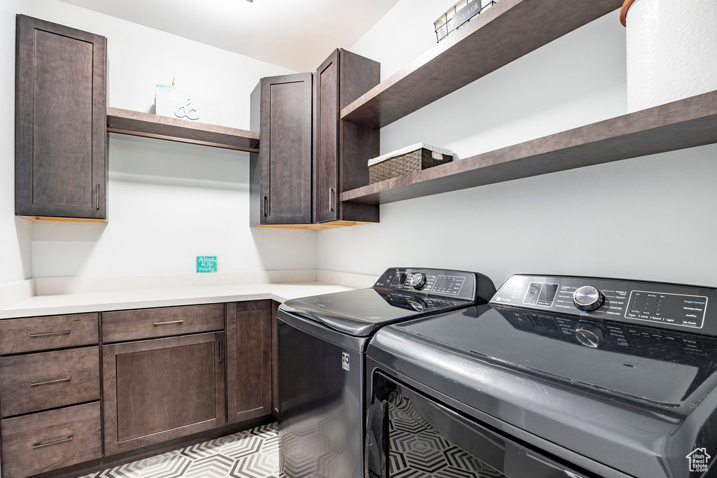 Laundry room featuring cabinet space and washer and dryer