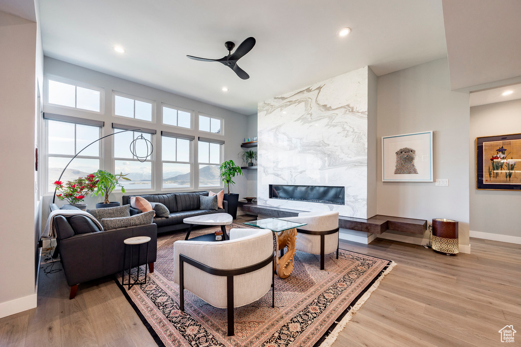 Living room featuring baseboards, ceiling fan, recessed lighting, and wood finished floors