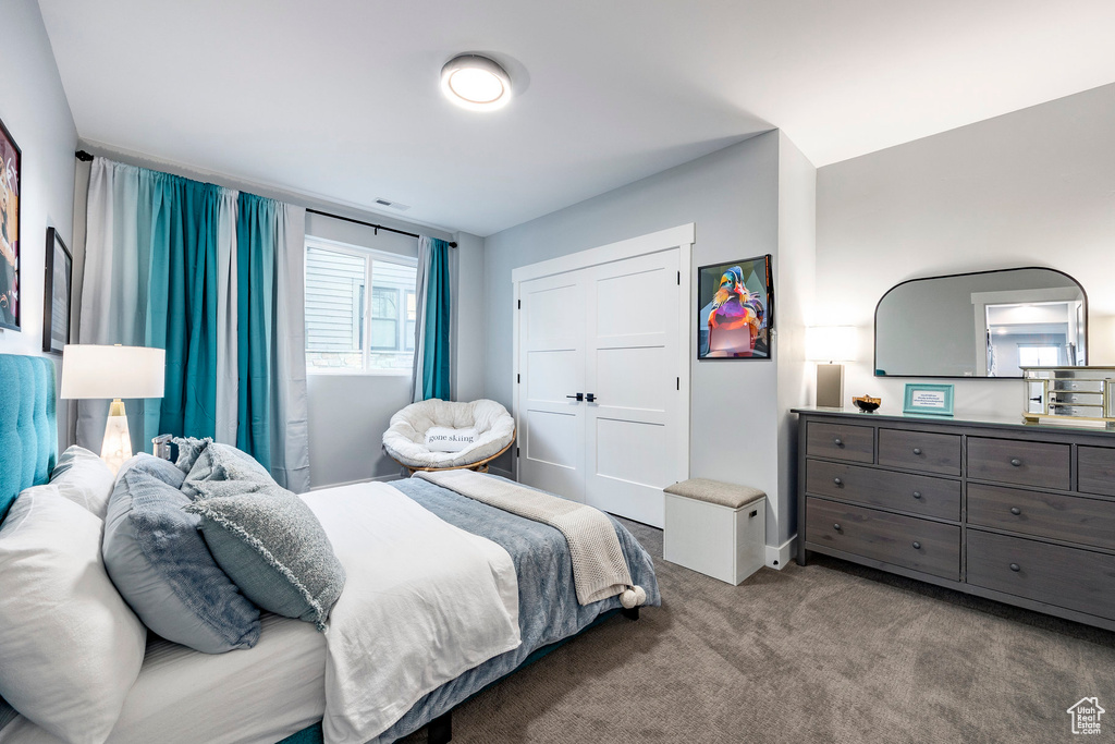Carpeted bedroom featuring visible vents and baseboards