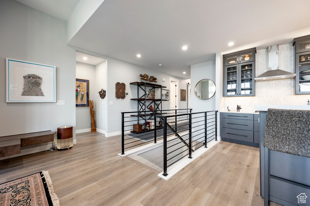 Interior space with light wood-type flooring, recessed lighting, baseboards, and an upstairs landing