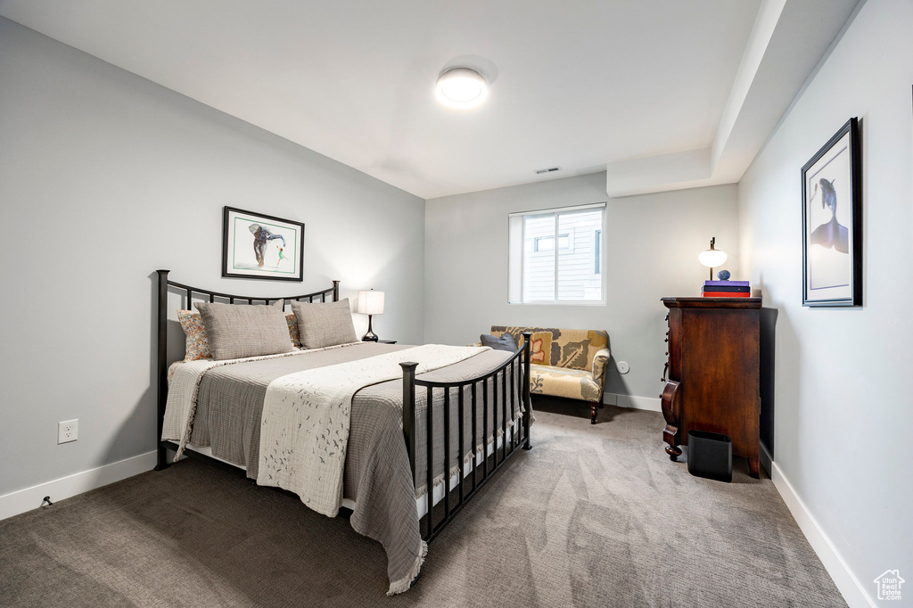 Bedroom featuring baseboards, visible vents, and carpet