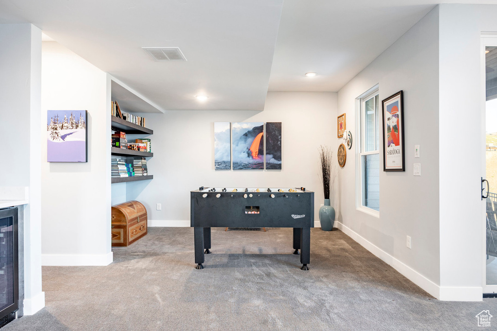 Recreation room featuring wine cooler, baseboards, carpet flooring, and visible vents