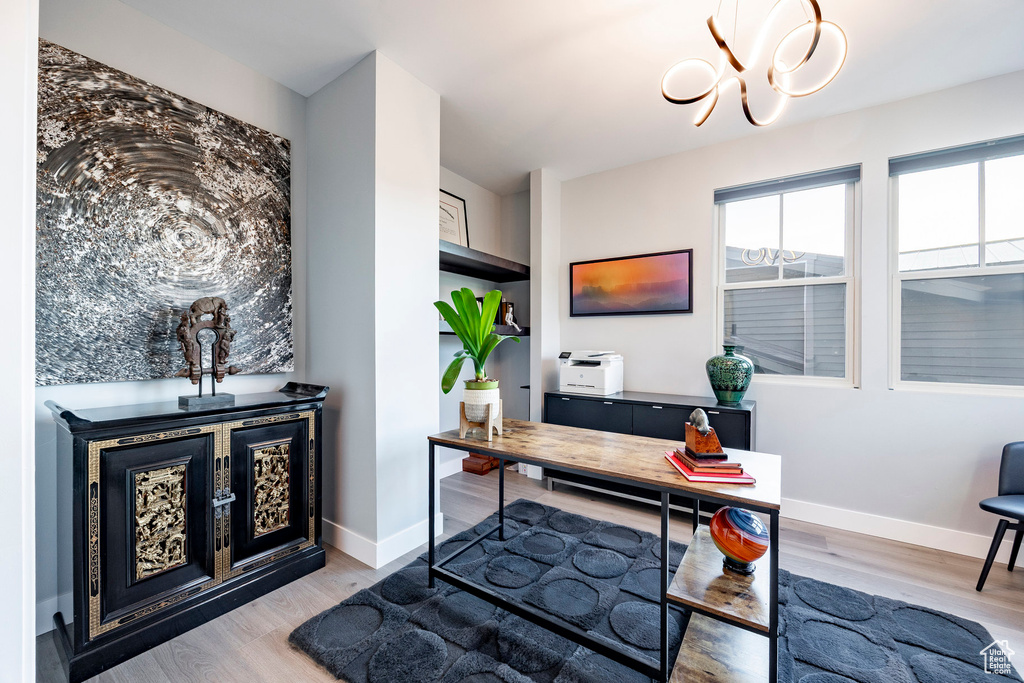 Office with an inviting chandelier, baseboards, and wood finished floors