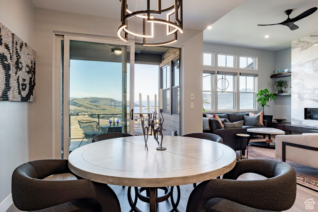Dining space featuring recessed lighting, a fireplace, a ceiling fan, and a mountain view